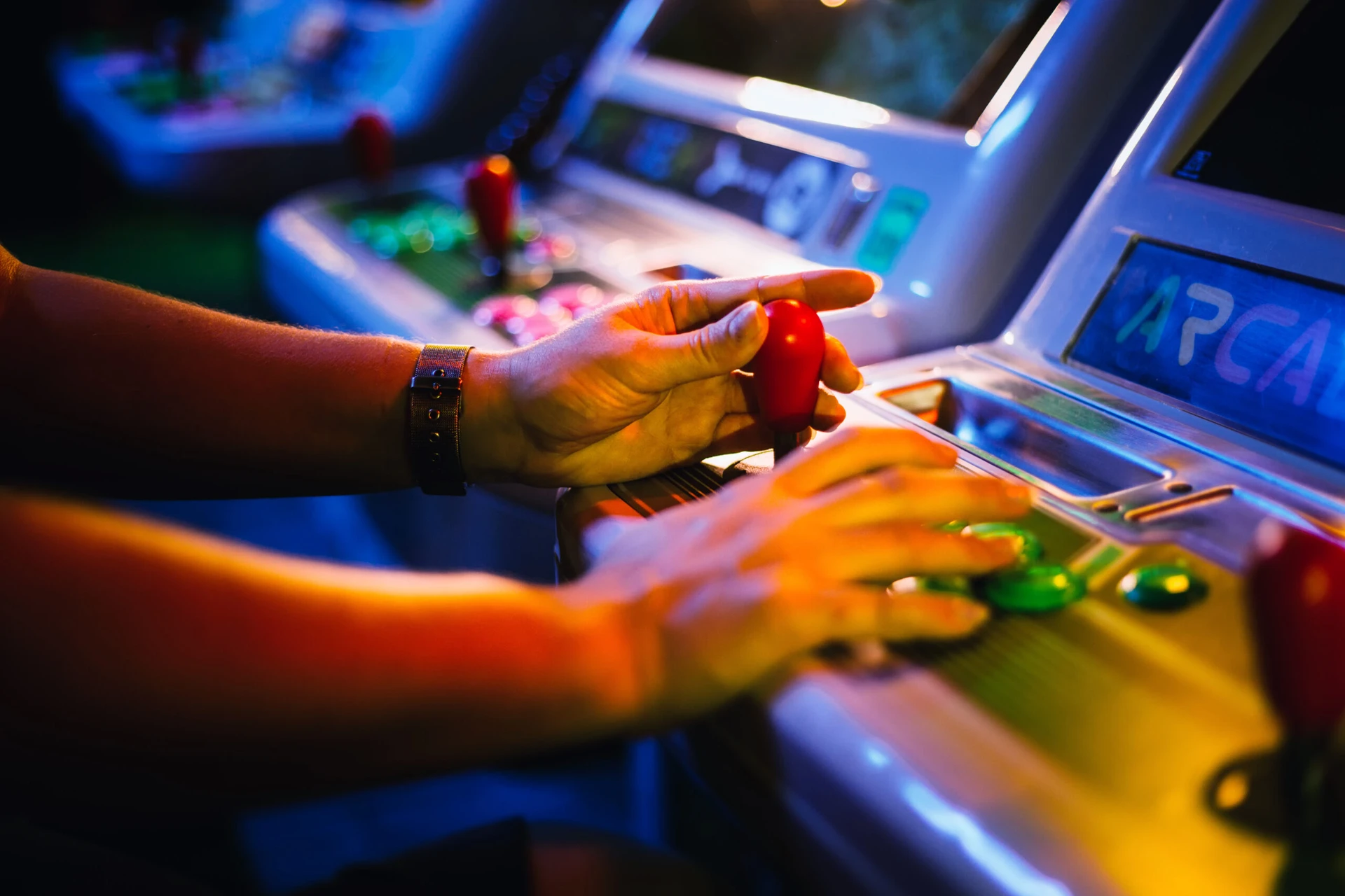 Detail On Hands With Arcade Joystick Playing Old Arcade Video Game